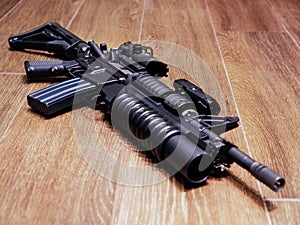 AR15 rifle with grenade launcher on the wooden floor