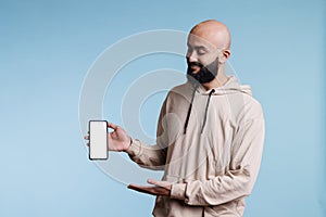 Arab advertiser presenting smartphone