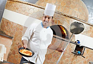 Arab baker chef making Pizza