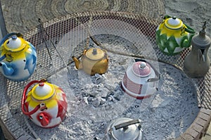 Arab Bedouin nomads use metal tea pots and smouldering coals