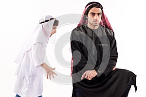 Arab boy screams at adult father in keffiyeh.