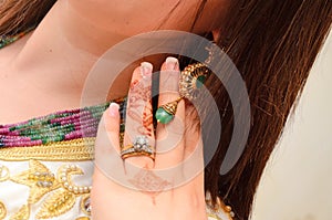 An Arab bride puts a henna tattoo with her wedding ring.