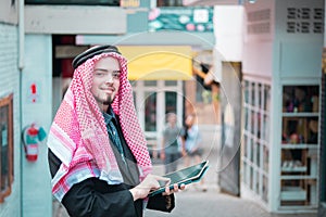 Arab business man standing and working at his market,