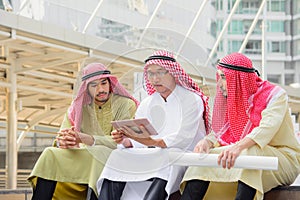 Arab Business people sitting and having consultation by using tablet.