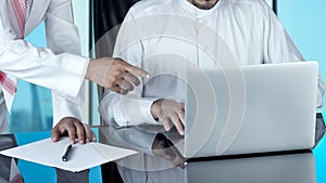 Arab Businessmen Working on a Laptop