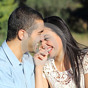 Arab casual couple flirting laughing happy in a park photo