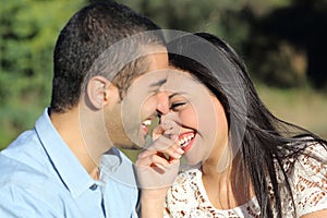 Arab casual couple man and woman flirting and laughing happy in a park