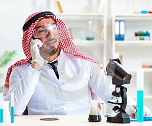 Arab chemist scientist testing quality of oil petrol