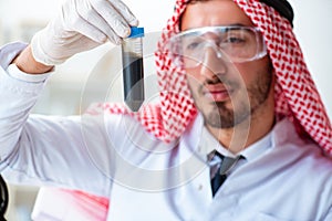 The arab chemist scientist testing quality of oil petrol