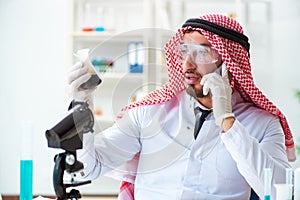 The arab chemist scientist testing quality of oil petrol