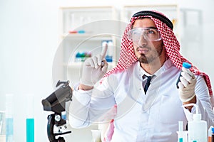 The arab chemist scientist testing quality of oil petrol