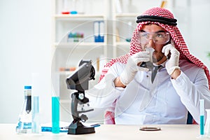 The arab chemist scientist testing quality of oil petrol