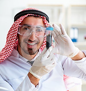 Arab chemist scientist testing quality of oil petrol