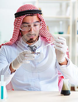 Arab chemist scientist testing quality of oil petrol