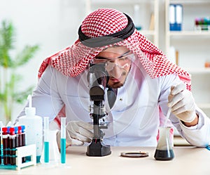 Arab chemist scientist testing quality of oil petrol