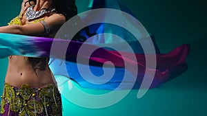 Arab dancer performs belly dance. Black background. Slow motion. Close up