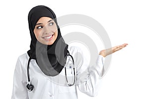 Arab doctor woman presenting with palm up photo