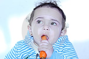 Arab egyptian baby girl eating carrot