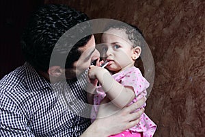 Arab egyptian man playing with his baby girl