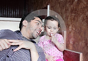 Arab egyptian man playing with his baby girl