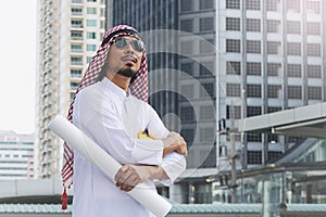 Arab Engineer construction worker holding blueprint