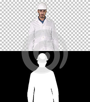 Arab engineer in helmet and white robe walking forward, Alpha Ch