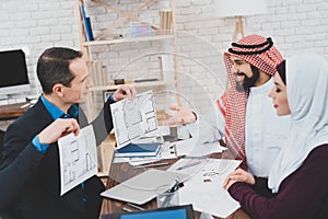 Arab family chooses a new apartment plan.