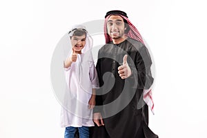Arab father and son in ethnic clothes