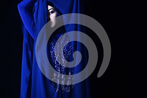 Arab girl in blue hijab, black eye