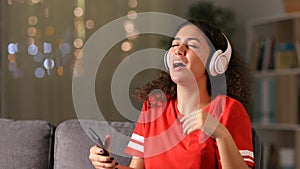 Arab girl dancing and listening to music at home