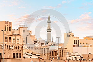 Arab houses and the towering minaret of the mosque in the neighborhood of Bur Dubai Creek and Golden Souk