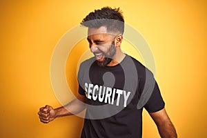 Arab indian hispanic safeguard man wearing security uniform over isolated yellow background very happy and excited doing winner