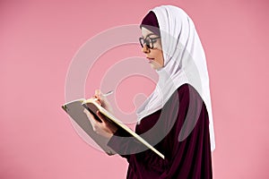 Arab intelligent woman in hijab makes notes