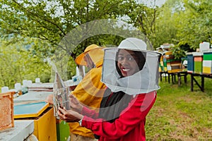 Arab investitor with an experienced senior beekeeper checking the quality and production of honey at a large bee farm photo