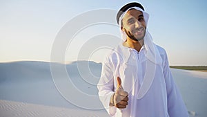 Arab male sales representative looks at camera and tells informa photo