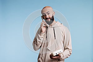 Arab man answering landline phone call