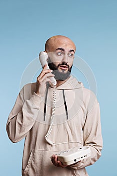 Arab man answering landline phone call