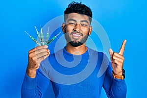 Arab man with beard holding picklock to unlock security door smiling happy pointing with hand and finger to the side