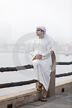 Arab man in Dubai in a foggy morning