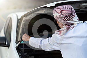 Arab man fixing his car outdoors