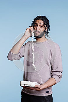 Arab man having conversation on landline phone