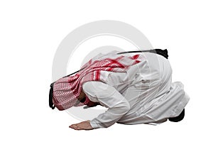 Arab man kneeling to pray , isolated white background in traditional costume. Ready for cutting and editing