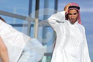 Arab man looking amazed a girl in the street