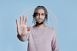 Arab man making stop gesture with hand portrait