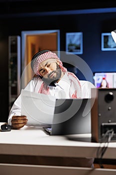 Arab man on phone at office desk