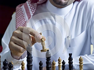 An Arab man playing chess at his desk 3