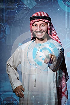 The arab man pressing virtual buttons in futuristic concept