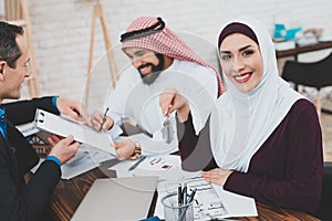 An Arab man puts a signature on a document.