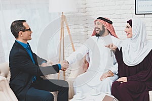 Arab man rejoices and shakes the hand of a realtor