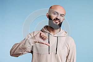 Arab man showing dislike with thumb down